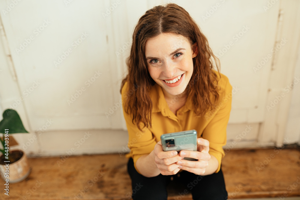 Pretty vivacious young redhead woman with a friendly smile Pretty vivacious young redhead woman with a friendly smile