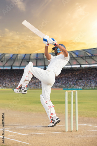 Cricketer batsman hitting a shot