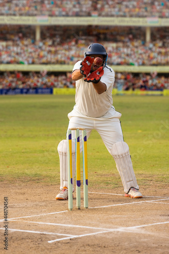  Wicketkeeper catching a throw at the stumps During a match in the stadium