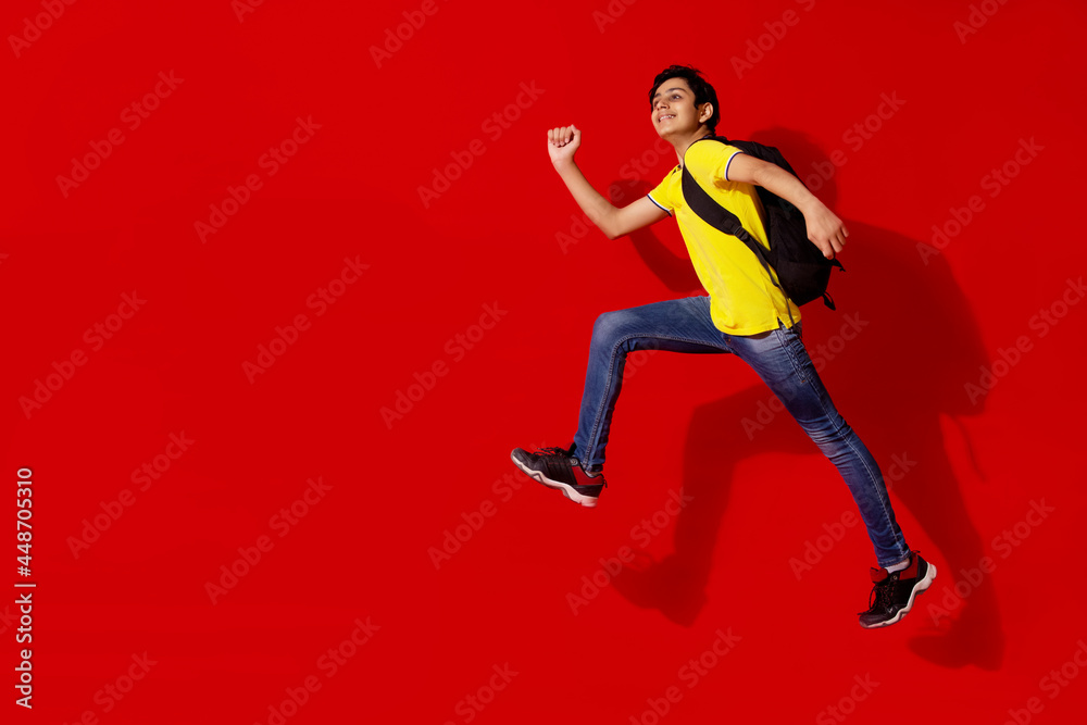 A HAPPY TEENAGER POSING WHILE JUMPING
