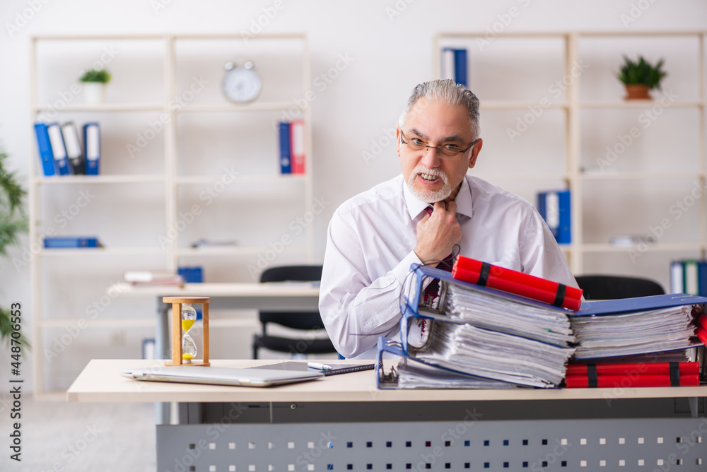 Old male employee with dynamite in the office Old male employee with dynamite in the office