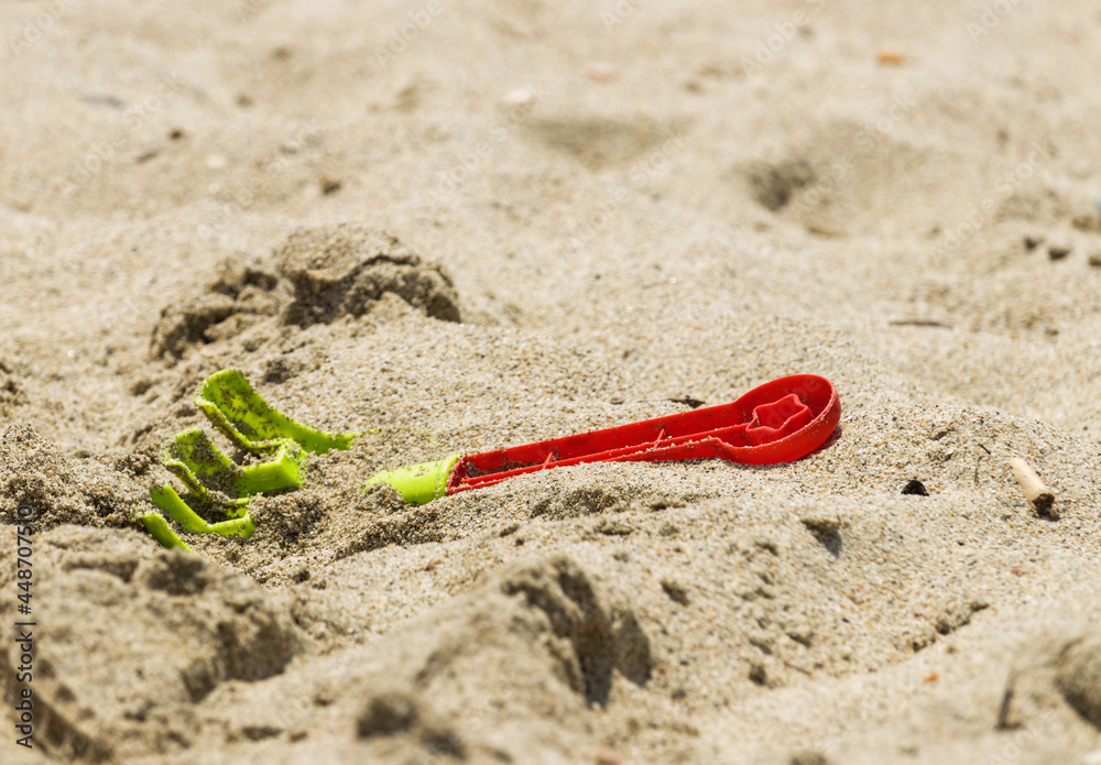 Plastic green-red children rake for playing in the sand Plastic green-red children rake for playing in the sand
