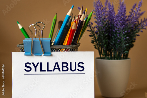 SYLLABUS - word on a white sheet against the background of pencils and a bouquet of lavender photo