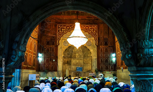 Muslims performing namaz (prayer) at historical Jama masjid of Delhi, India photo