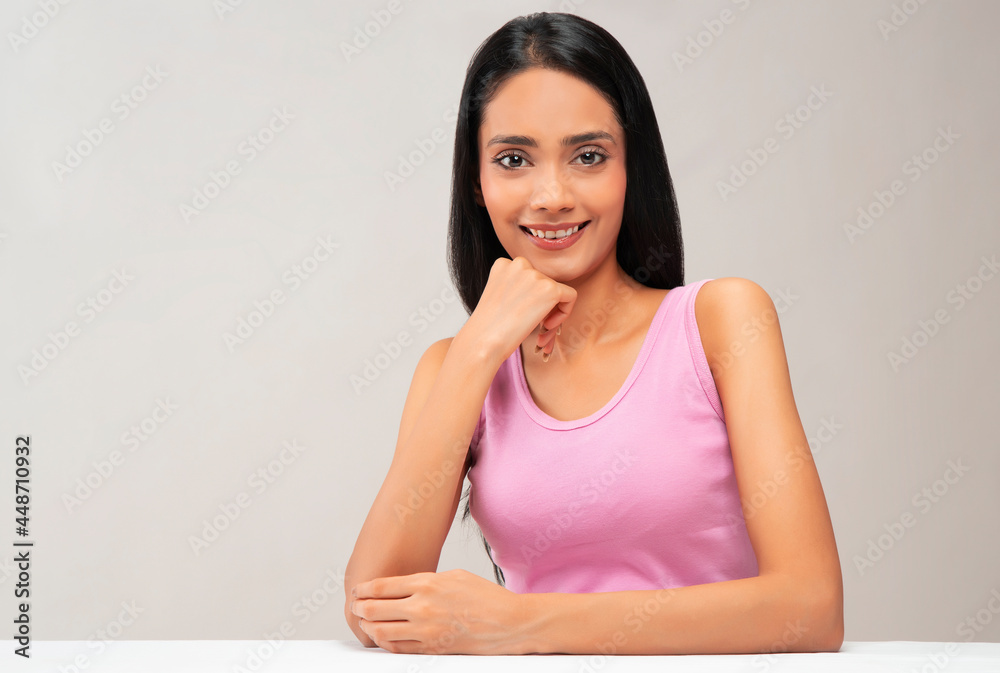 Portrait of a young woman with clear,spotless skin smiling.