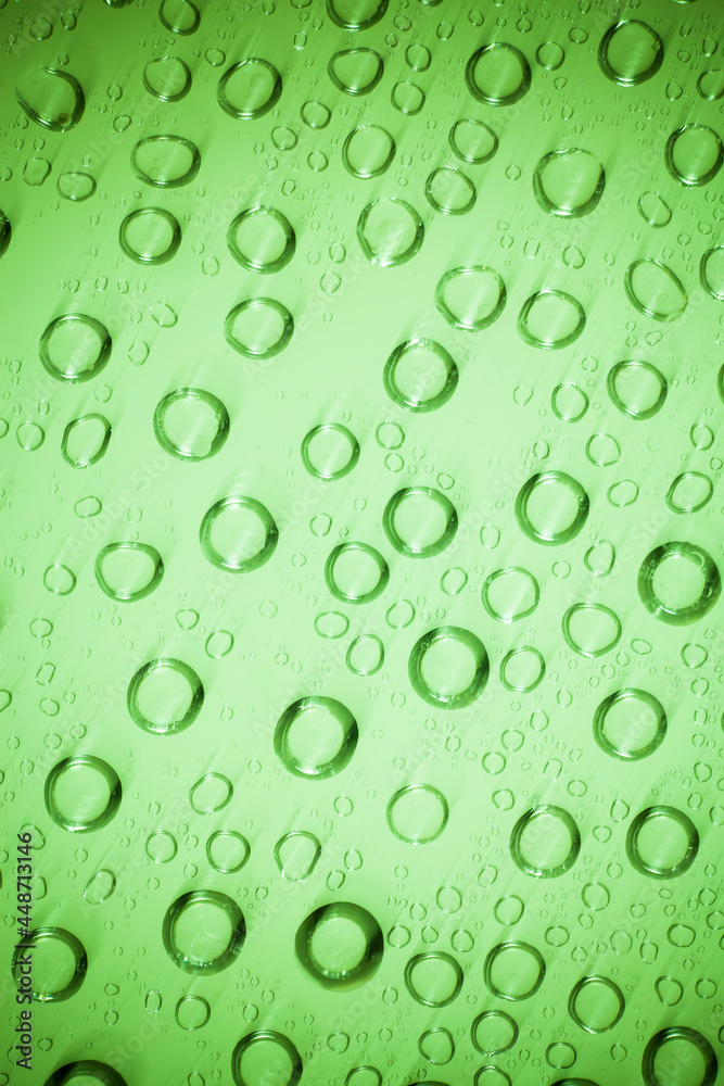 Water bubble on green glass.