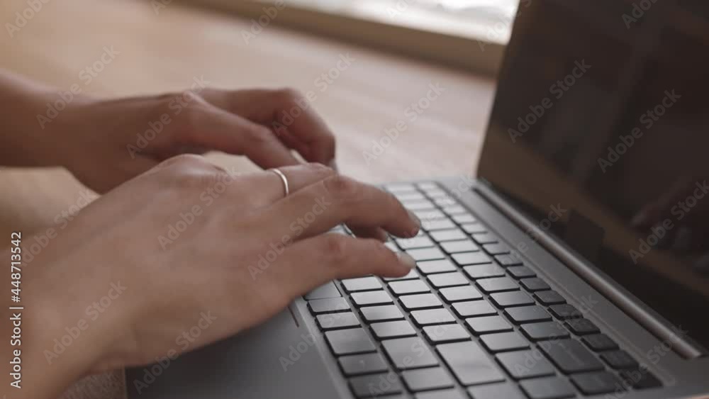 Close-up of female hands typing on keyboard of portable computer Close-up of female hands typing on keyboard of portable computer