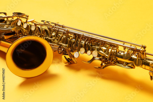 Fotografía Beautiful saxophone on yellow background, closeup view