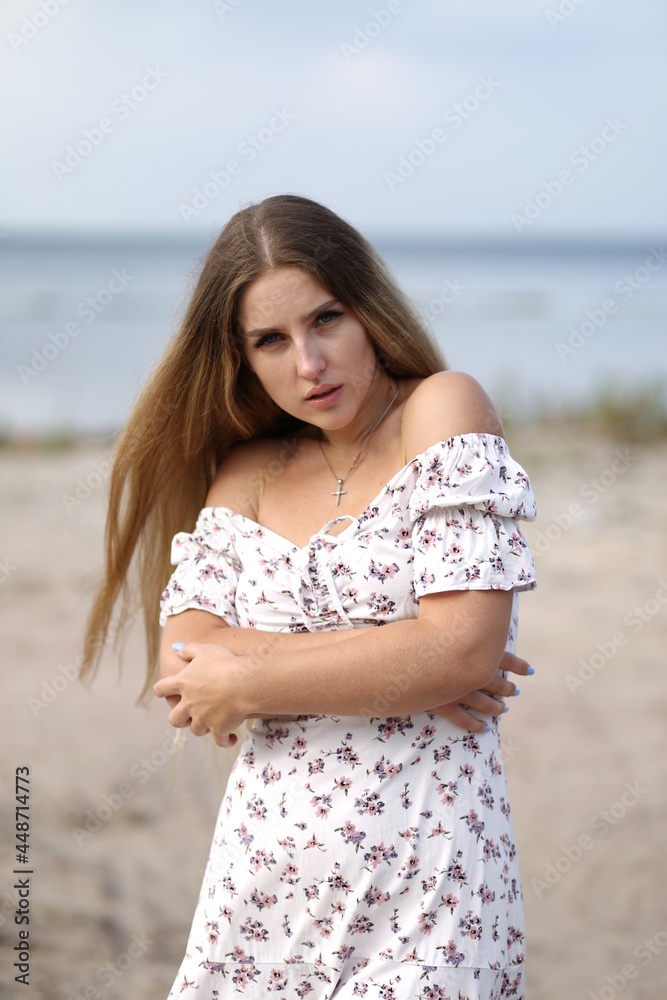 Young towheaded woman in white dress at the beach Young towheaded woman in white dress at the beach