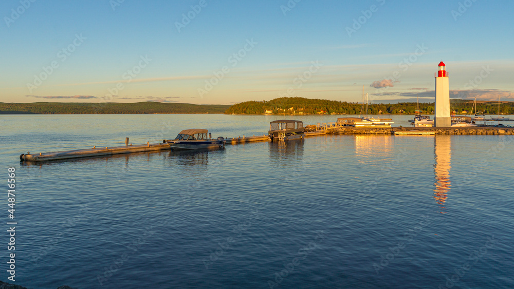 Sunset over the Cabano lighthouse and Temiscouata's marina, with the paper mills smoke in the background