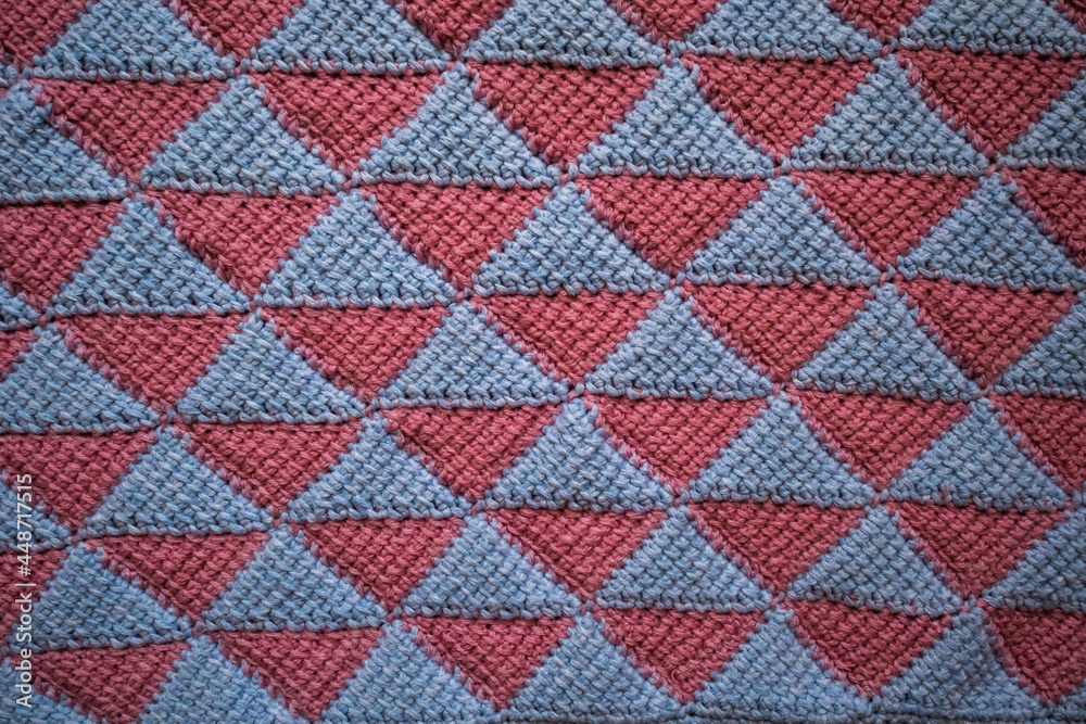 The canvas is crocheted in pink blue. The pattern of triangles is made in the style of Tunisian knitting. The canvas is crocheted in pink blue. The pattern of triangles is made in the style of Tunisian knitting.