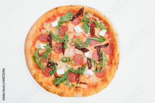Delicious italian pizza over white background top view