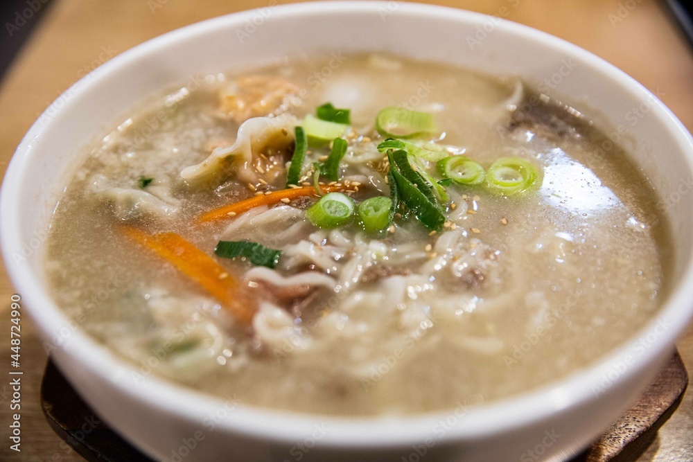 Kalguksu with vegetables and green onion in noodles kneaded with flour and cut with a knife, Korean traditional food Kalguksu with vegetables and green onion in noodles kneaded with flour and cut with a knife, Korean traditional food