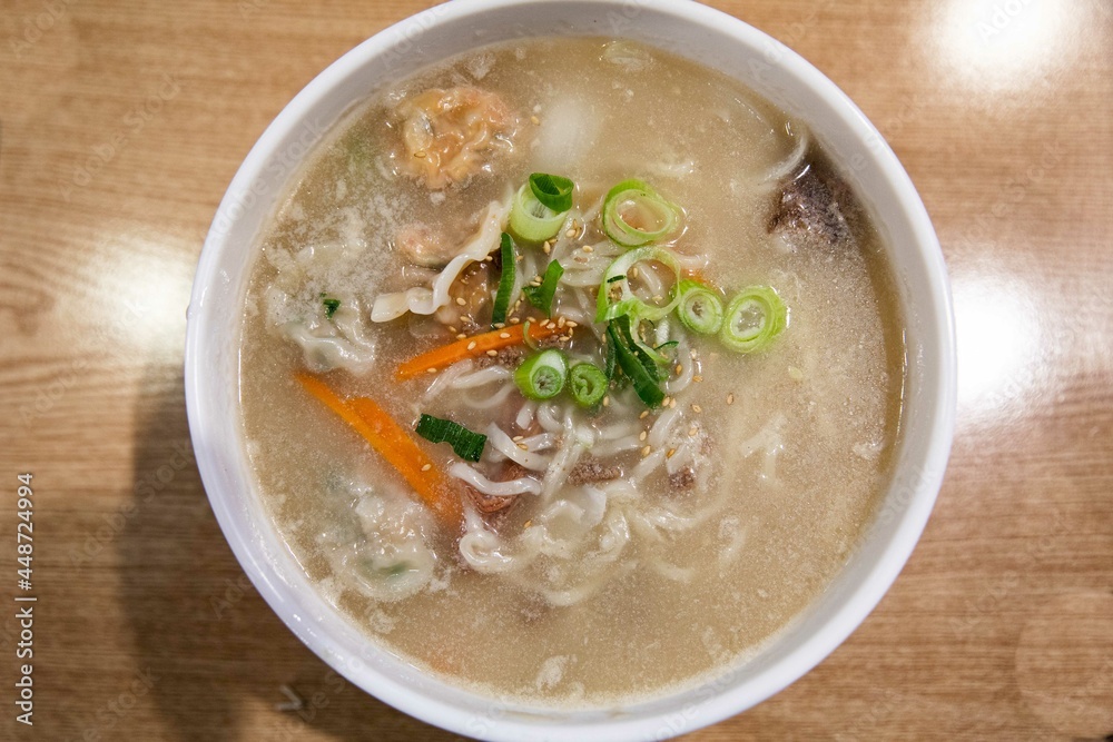 Kalguksu with vegetables and green onion in noodles kneaded with flour and cut with a knife, Korean traditional food Kalguksu with vegetables and green onion in noodles kneaded with flour and cut with a knife, Korean traditional food