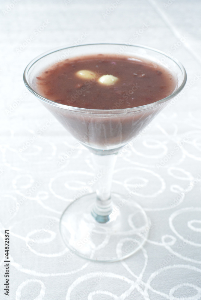 chilled red bean paste soup in cocktail glass in white background asian halal menu chilled red bean paste soup in cocktail glass in white background asian halal menu