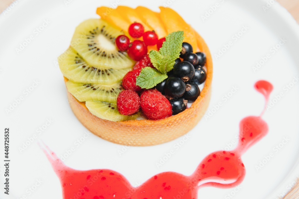 Delicious cheesecake with berries on table close up