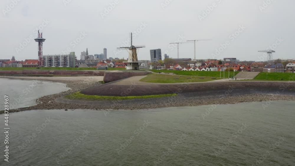 Aerial low-altitude shot of a beautiful windmill Oranjemolen in Vlissingen, Zeeland, The Netherlands Aerial low-altitude shot of a beautiful windmill Oranjemolen in Vlissingen, Zeeland, The Netherlands