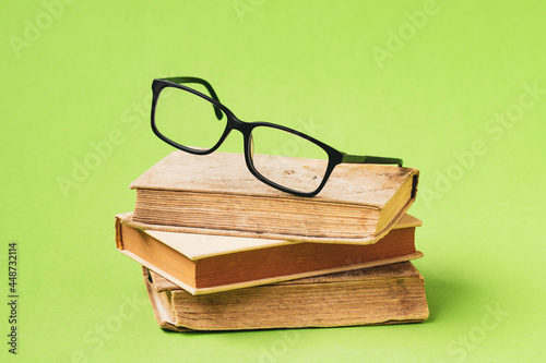 Eyeglasses laid up on an old books
