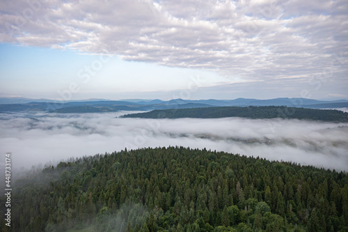 Aerial view on mountains in clouds from drone