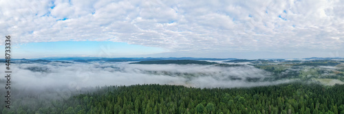 Aerial view on mountains in clouds from drone © Ruslan