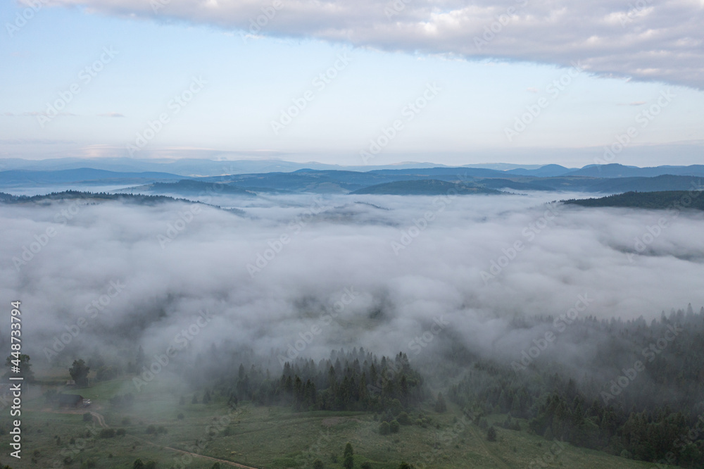 Aerial view on mountains in clouds from drone