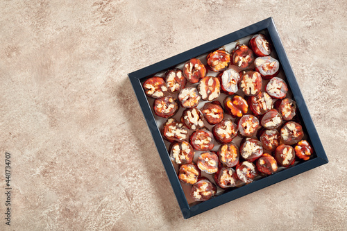 Sliced pieces of delicious churchkhela delight with walnut in a box