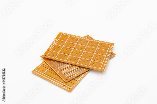 Perfboard used to build DIY electronic circuit isolate on white background photo