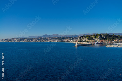City of Nice in France, pier on Mediterranean Sea with Phare de Nice lighthouse on French Riviera