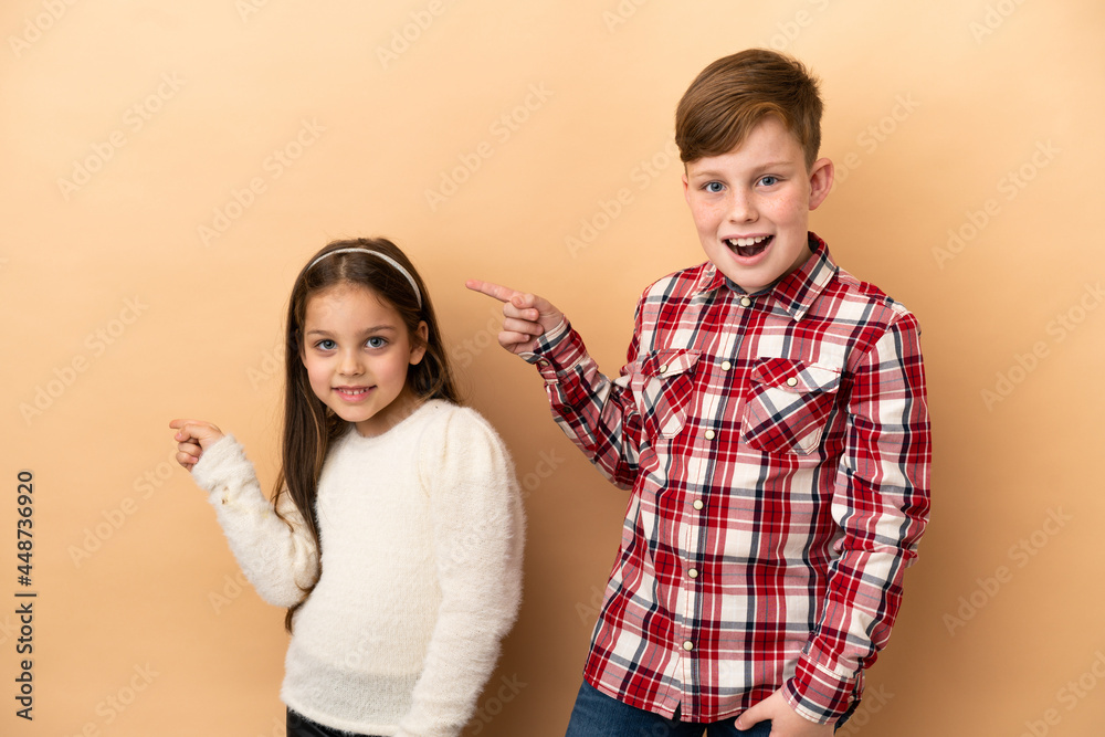 Little caucasian brothers isolated on beige background Little caucasian brothers isolated on beige background