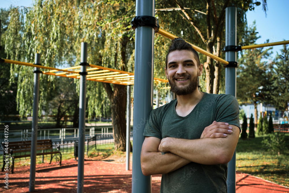 Active lifestyle concept. Young man is standing on equipped outdoor ...