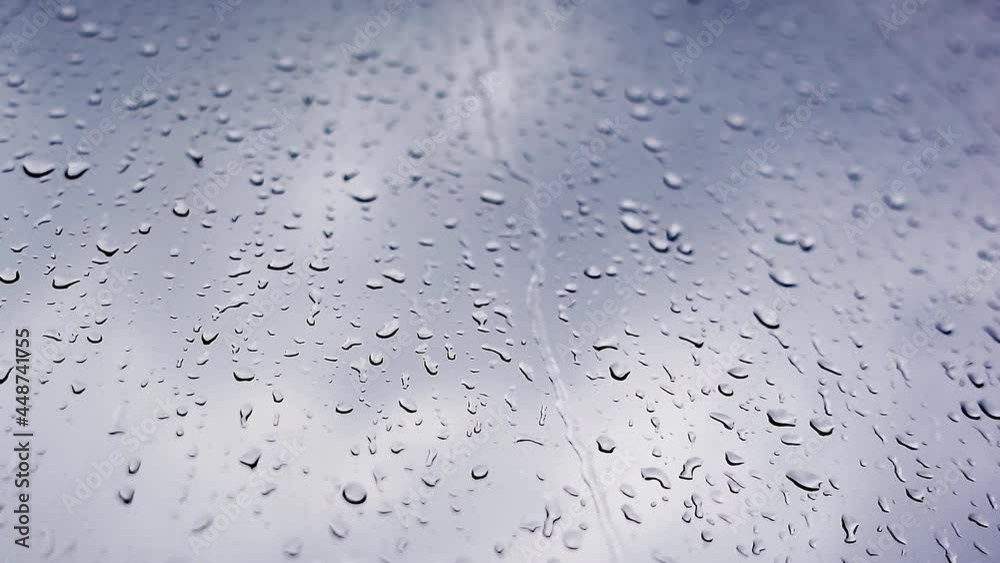 4K raw video of raindrops falling on a window close-up against a gray sky. 4K raw video of raindrops falling on a window close-up against a gray sky.