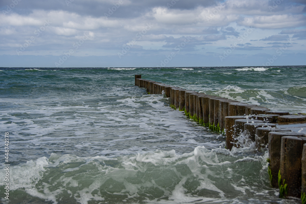 Wooden groynes in the rough Baltic Sea on the Fischland-Darß-Zingst peninsula