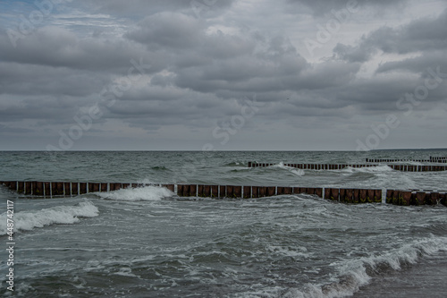 Wooden groynes in the Baltic Sea on a stormy summer day
