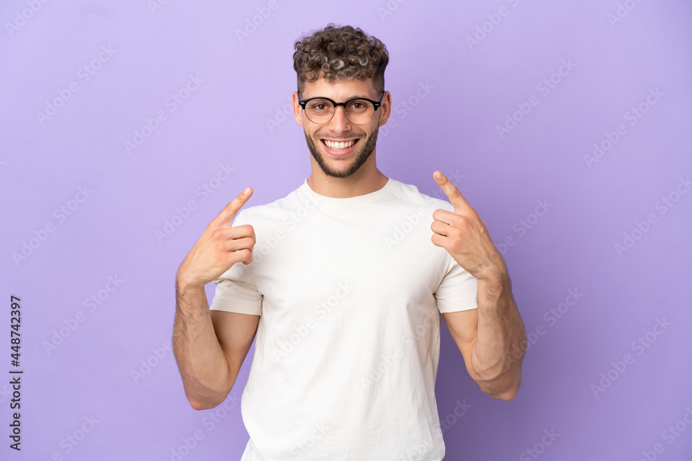 Delivery caucasian man isolated on purple background giving a thumbs up gesture Delivery caucasian man isolated on purple background giving a thumbs up gesture