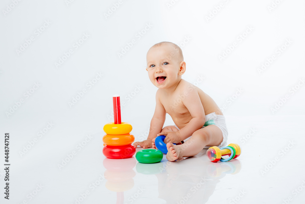 a baby boy with a multi-colored pyramid is isolated on a white background; a baby boy with a multi-colored pyramid is isolated on a white background;