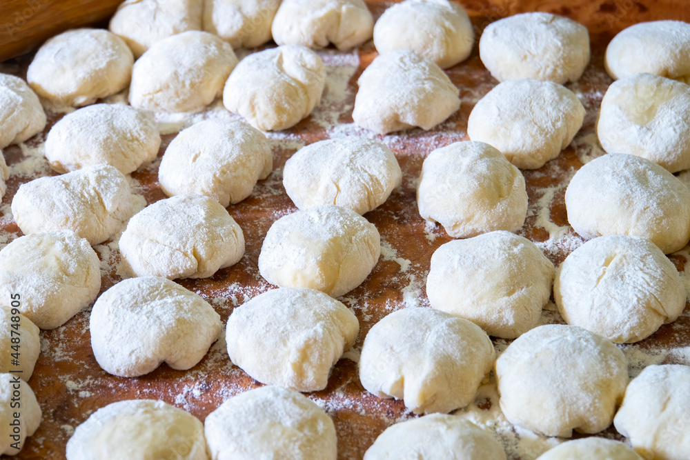 Three balls of fresh homemade wheat dough on kitchen table Three balls of fresh homemade wheat dough on kitchen table