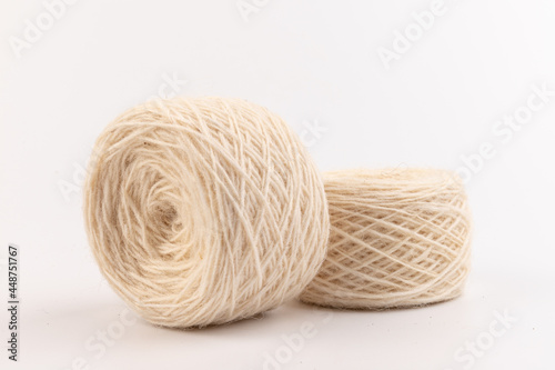 balls of light woolen thread on white background. natural wool. knitting. background