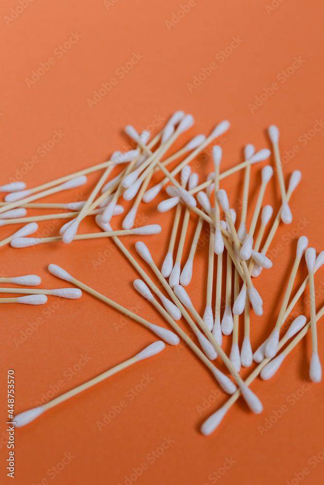 Bamboo cotton swabs on orange table. Zero waste, plastic free lifestyle concept Bamboo cotton swabs on orange table. Zero waste, plastic free lifestyle concept