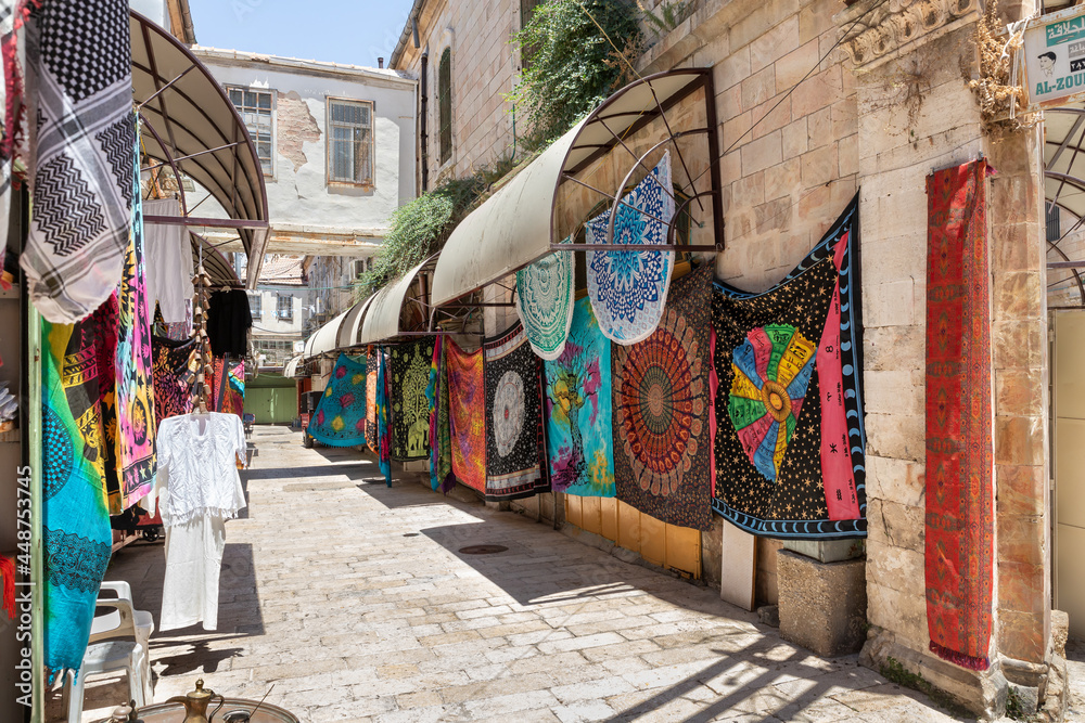 Decorative bedspreads and other souvenirs are sold on Al Souq Street in Muristan, in Christian quarters in the old city of Jerusalem, Israel