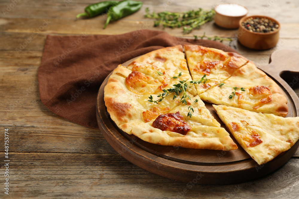 Delicious khachapuri with cheese on wooden table Delicious khachapuri with cheese on wooden table