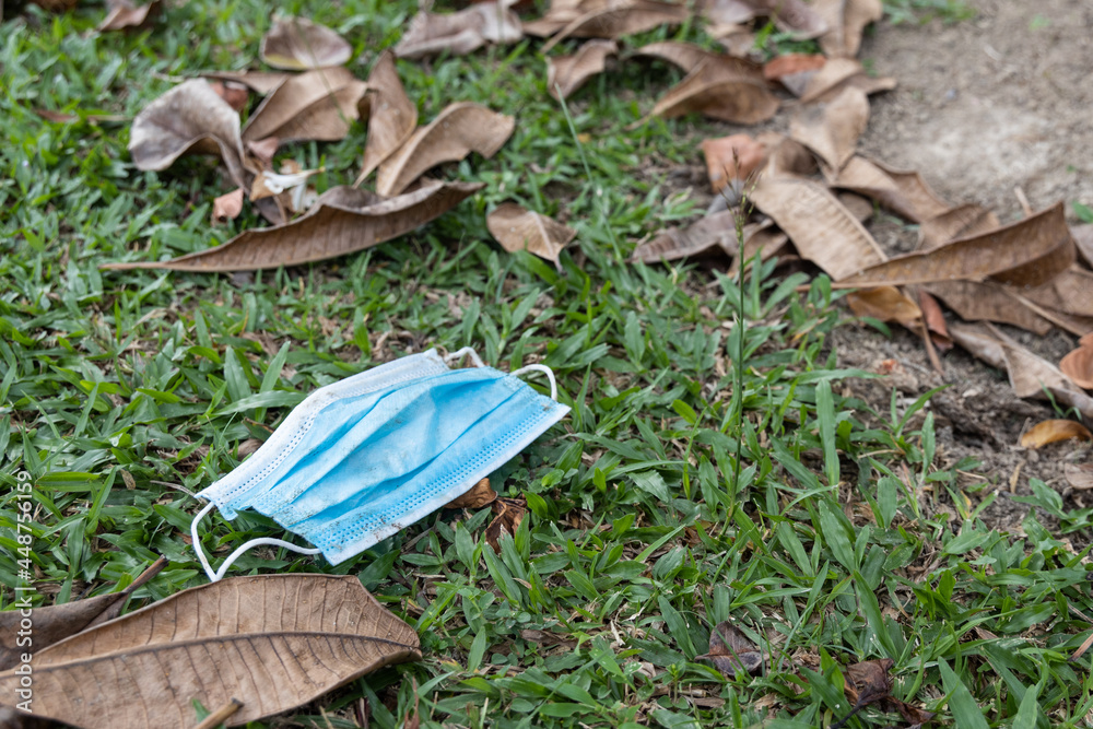 Fototapeta premium Litter of used surgical face mask with high usage due to covid pandemic polutes the environment