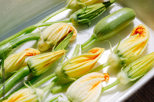 zucchini flowers in varying degrees of disclosure, ready to cook