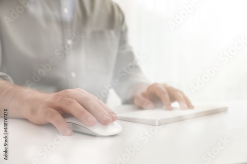 Man using computer mouse at desk, closeup