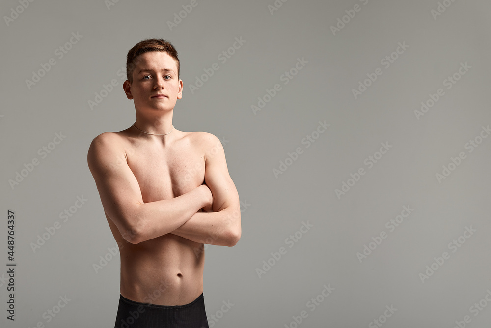 Young swimmer in excellent physical shape, on a gray background with copy space, call for sports, advertising banner