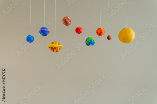 Toy planets made by kid from colorful molding clay indoor