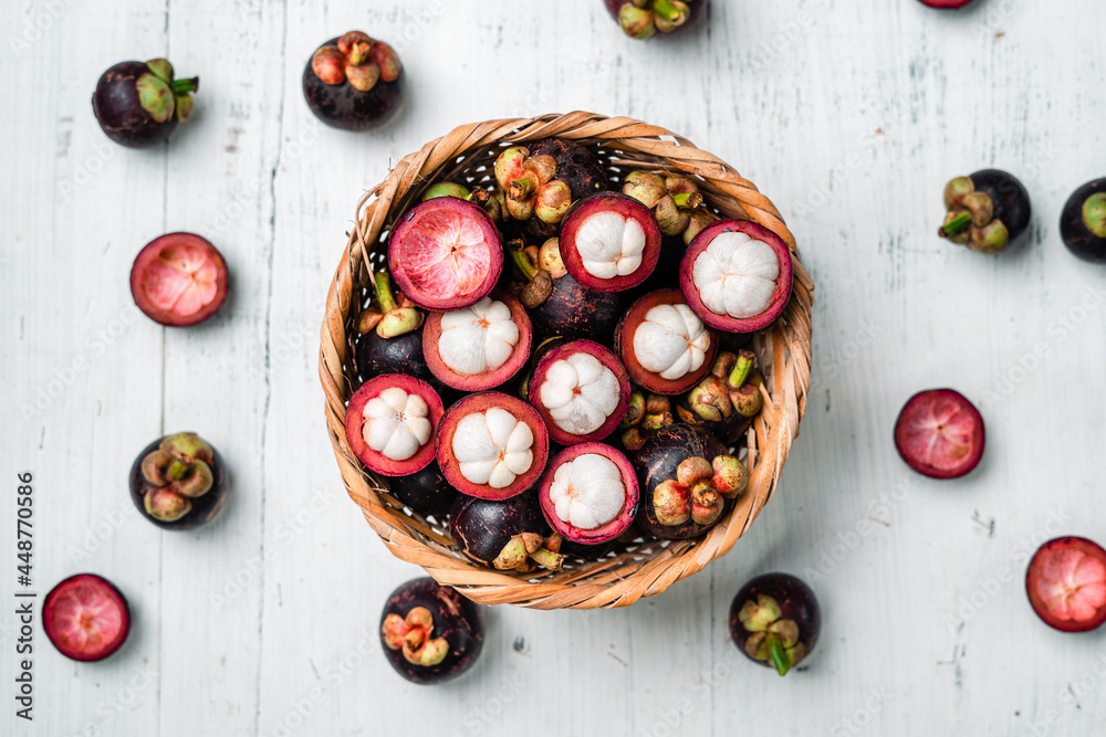 Mangosteen fruit on white wooden background Mangosteen fruit on white wooden background