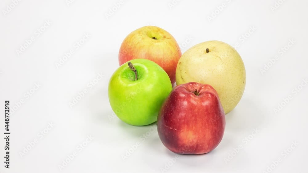 Green, red, yellow apples rotation on a white background, eating timelapse. Green, red, yellow apples rotation on a white background, eating timelapse.