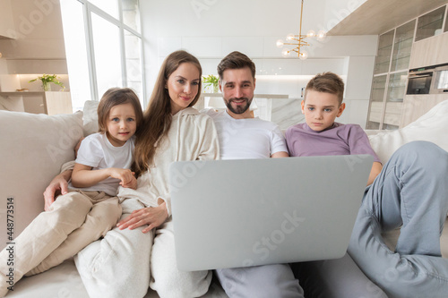 Family browsing internet in living room
