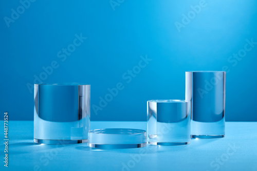  Crystal background with various geometrical forms and glass podiums, circle in bluecolor for product presentation. Podium to show cosmetic products.