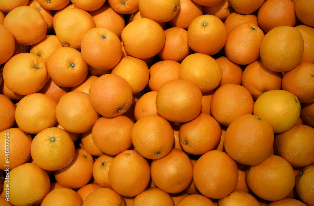 Image of orange fruit on a market stall. A pile of fresh tangerines waiting to be sold in the supermarket. Used for background, fruit wallpaper. Image of orange fruit on a market stall. A pile of fresh tangerines waiting to be sold in the supermarket. Used for background, fruit wallpaper.
